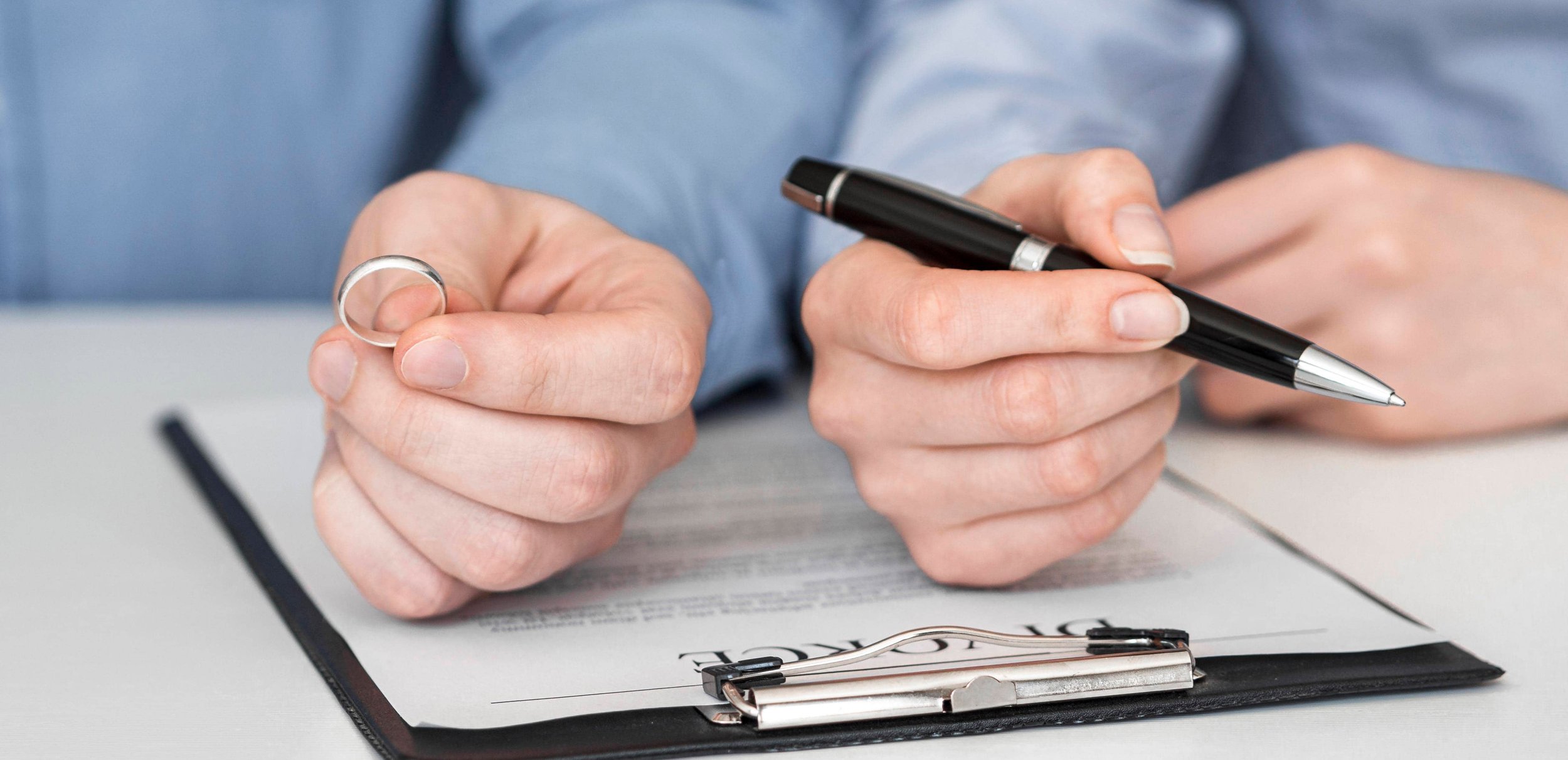 Client signing legal agreement with folded hands