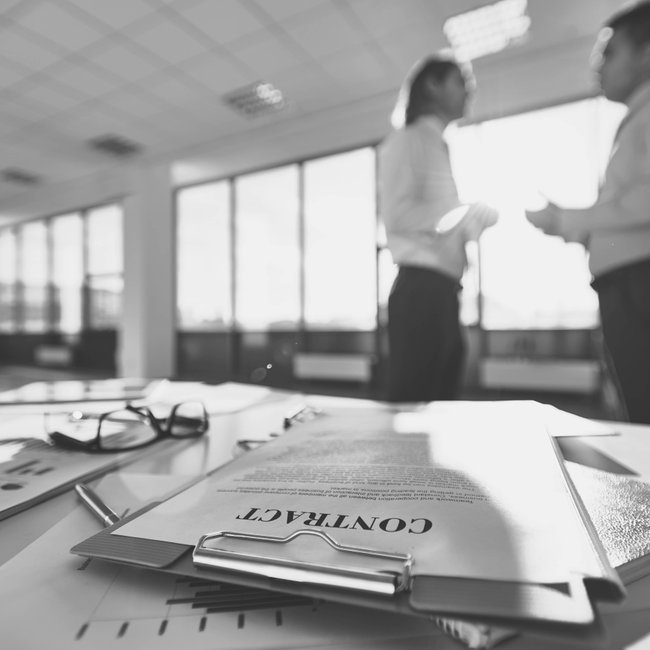 Legal documents and contract paperwork spread on desk